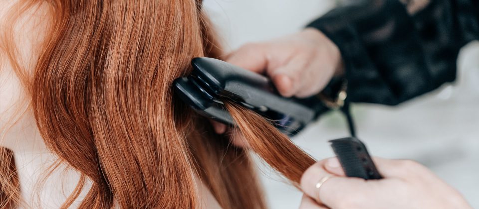 woman having her hair styled