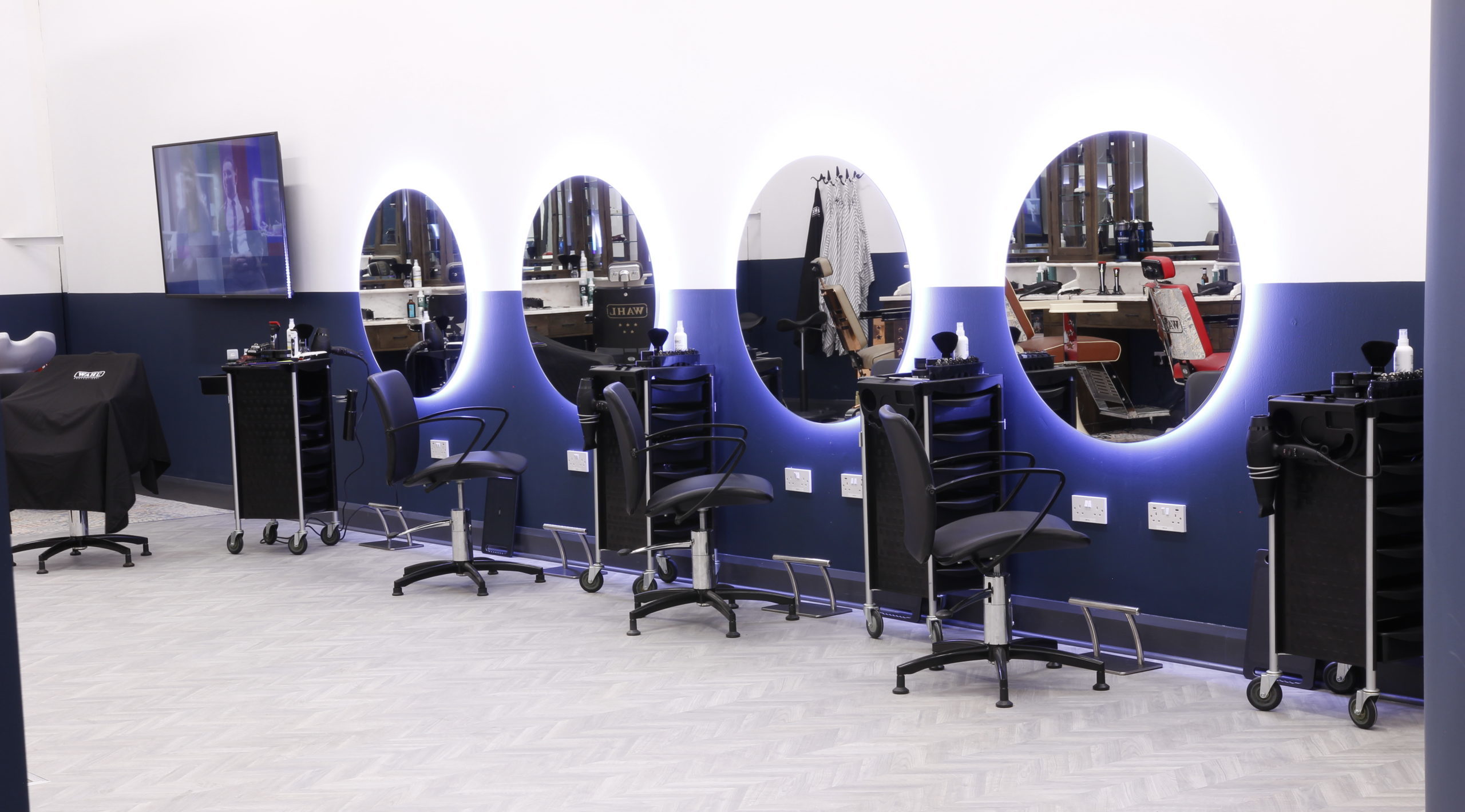 barbers chairs in front of mirrors